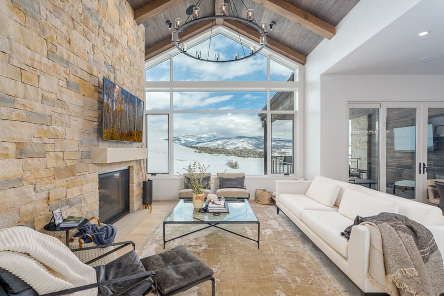 modern living room with stone wall and white couches