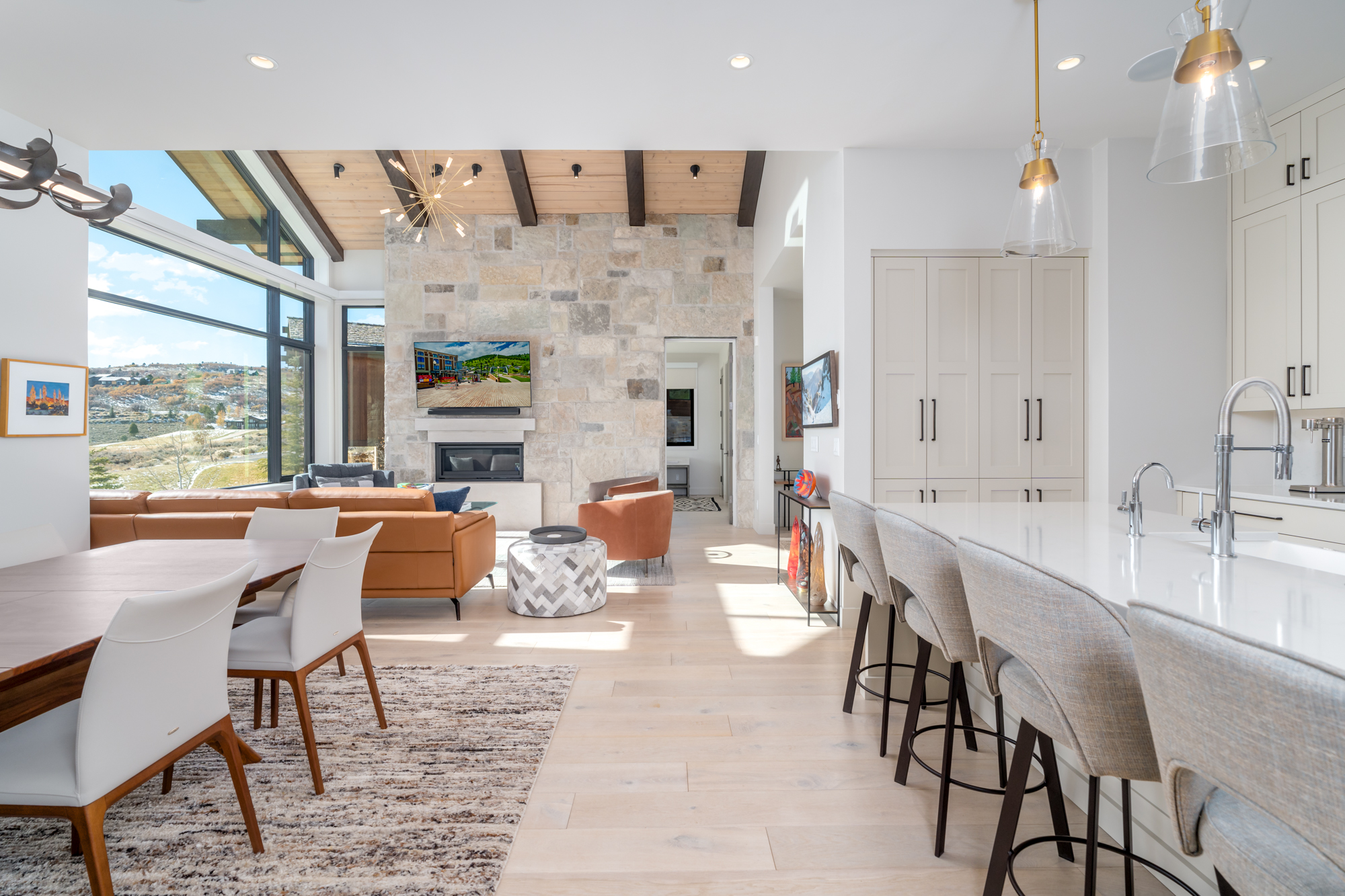 An architectural photo of a kitchen, dining room, and living room